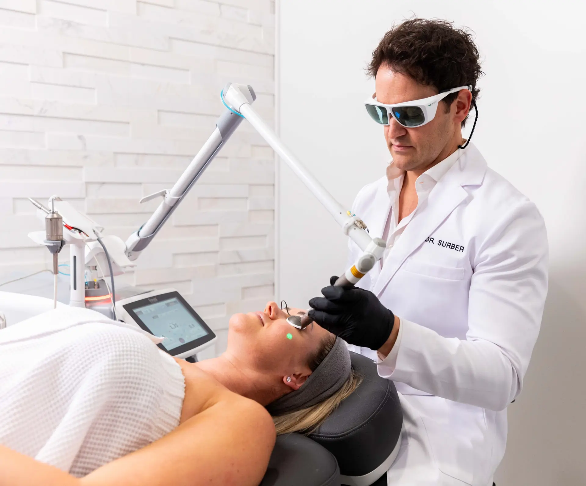 Physician performing a laser skin treatment at Icon Aesthetics