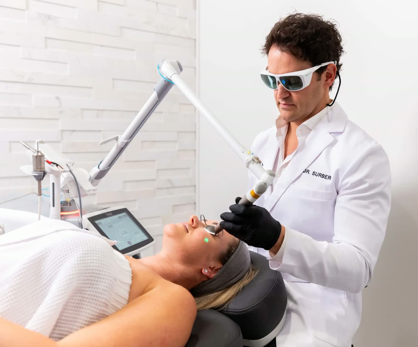 Physician performing a laser skin treatment at Icon Aesthetics